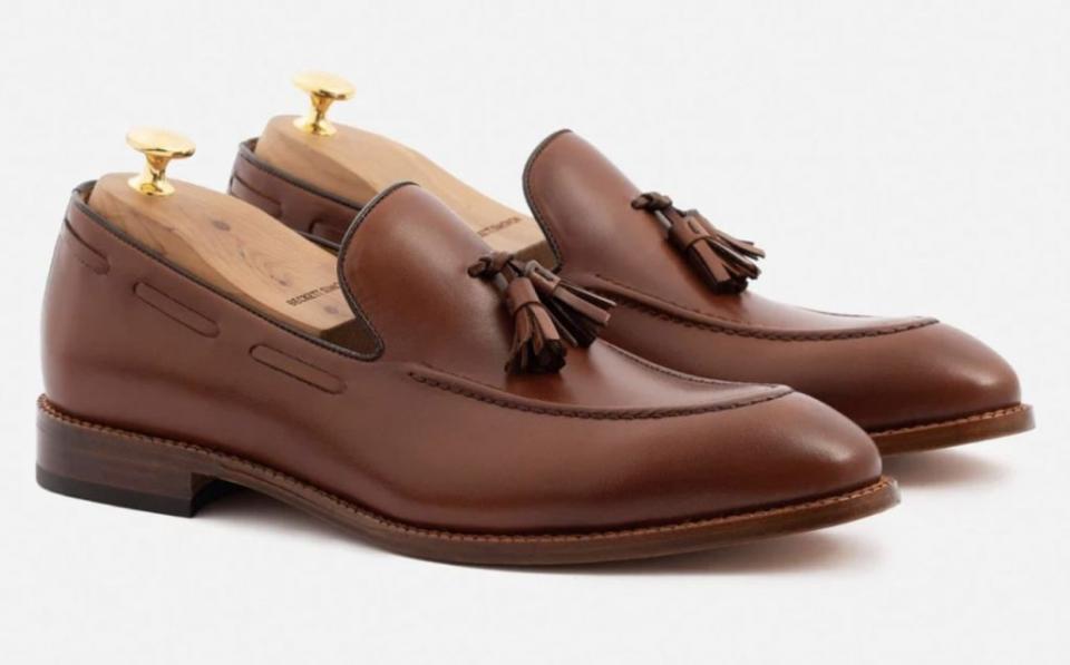 Brown loafers with tassles.