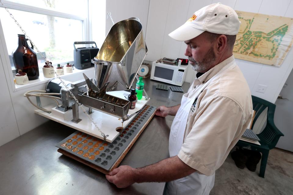 Steve Sandel, 58 of Shepherd and known as "The Candyman" at Shepherd Sugar Bush Corp. in Mt. Pleasant, moves around the mold as maple syrup is poured in to make maple candy on Saturday, April 22, 2023. 
The candy will be for sale at next weekends Shepherd Maple Syrup Festival which raises money for the town which will go through 1,450 gallons of maple syrup, 7,000 pounds of sausage and 2,600 pounds of pancake mix during the three day event.