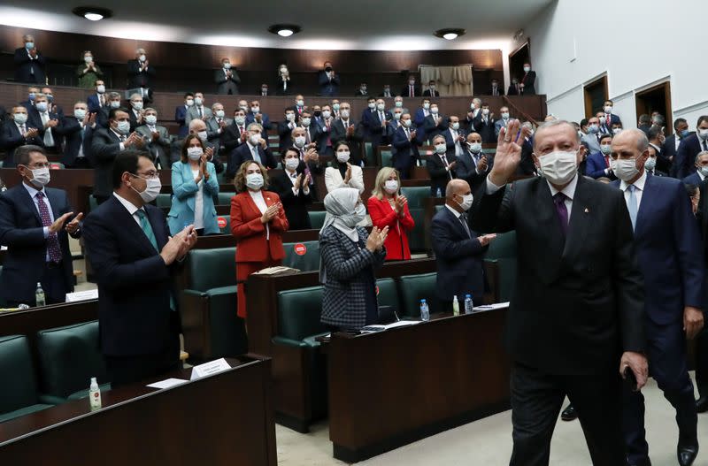 Turkish President Erdogan greets members of his ruling AKP during a meeting at the parliament in Ankara