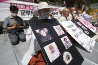 South Korean Buddhist monks and believers pray during a rally against Myanmar's recent executions of activists, in front of the Myanmar Embassy in Seoul, South Korea, Thursday, July 28, 2022. The U.N. Security Council on Wednesday unanimously condemned Myanmar’s executions of four political prisoners and called for an immediate halt to all violence and "full respect for human rights and the rule of law." (AP Photo/Ahn Young-joon)