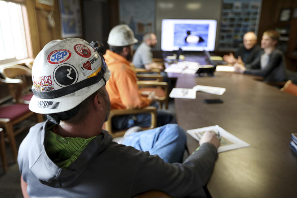 In this March 5, 2020, photo, miners go through a bird identification exercise before they start their shift for Montana Resources in Butte, Montana. The Trump administration is moving to scale back criminal enforcement of a century-old law protecting most American wild bird species. Mark Thompson, the manager of environmental affairs at Montana Resources, said it would keep up the efforts that drive away almost all birds regardless of the Trump administration’s actions, mirroring pledges from some other companies and industries. (Meagan Thompson/The Montana Standard via AP)