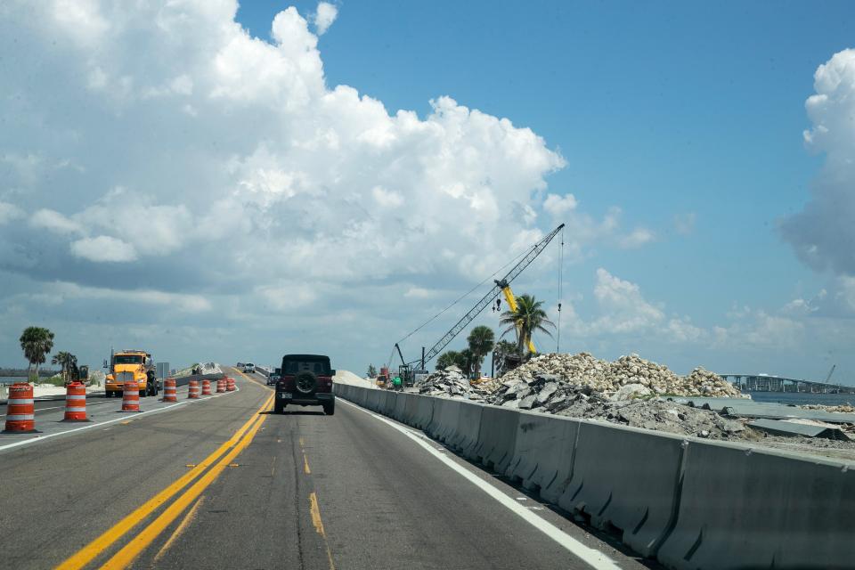 Work continues on the Sanibel Causeway on Thursday, Sept 7, 2023. Crews are paving new lanes as cranes and backhoes work in other areas to improve the roadway.