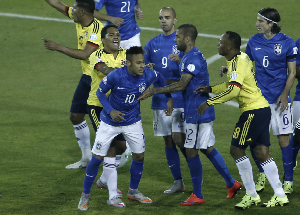 In this Wednesday, June 17, 2015 photo, Colombia&#39;s Carlos Bacca, second left, pushes Brazil&#39;s Neymar, 10, during a scuffle at the end of a Copa America Group C soccer match at the Monumental stadium in Santiago, Chile. Colombia won the match 1-0. (AP Photo/Silvia Izquierdo)