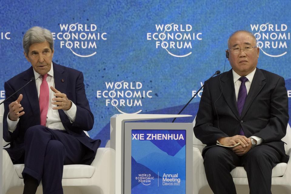 John F. Kerry, Special Presidential Envoy for Climate of the United States, left, gestures besides Xie Zhenhua, Special Envoy for Climate Change of the People's Republic of China, during the World Economic Forum in Davos, Switzerland, Tuesday, May 24, 2022. The annual meeting of the World Economic Forum is taking place in Davos from May 22 until May 26, 2022. (AP Photo/Markus Schreiber)