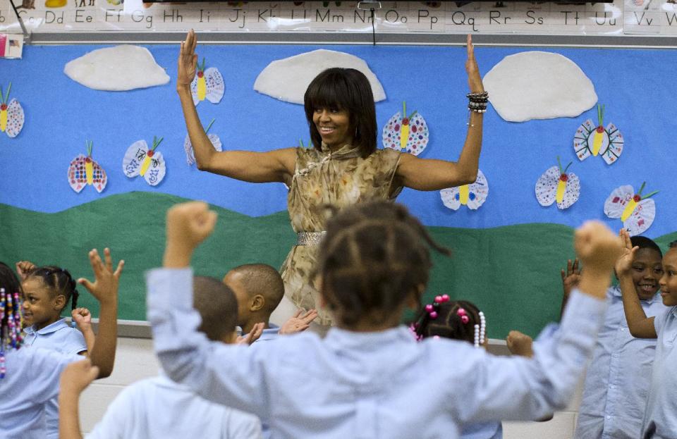 First lady Michelle Obama dances with a pre-K class at Savoy Elementary School in Washington, Friday, May 24, 2013. The Savoy School was one of eight schools selected last year for the Turnaround Arts Initiative at the President's Committee on the Arts and Humanities. Turnaround Arts Schools use the arts as a central part of their reform strategy to improve low performing schools (AP Photo/Evan Vucci)