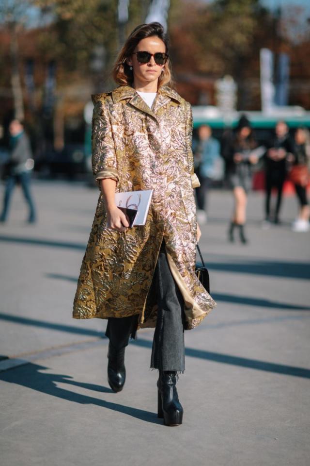 Miroslava Duma wearing a black coat and Louis Vuitton bag outside