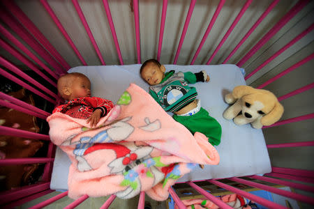 Children of Islamic State fighters, who suffer from malnourishment, sleep at a hospital in Hasaka, northeastern Syria, April 5, 2019. REUTERS/Ali Hashisho