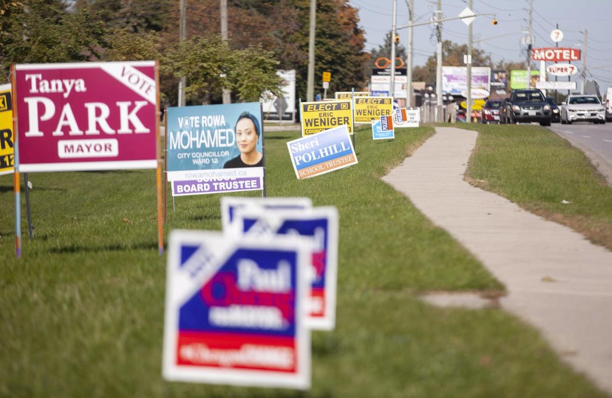 Traffic passes by election signs on Wellington Road in London, Ont., on Oct. 22, 2018, municipal election day in Ontario. THE CANADIAN PRESS/Geoff Robins
