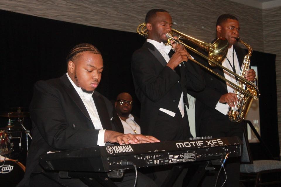 Neziah Curtis, left, Ian Rentz, center and Zachery Galloway, right, performed during the ball.
(Photo: Photo by Voleer Thomas/For The Guardian)