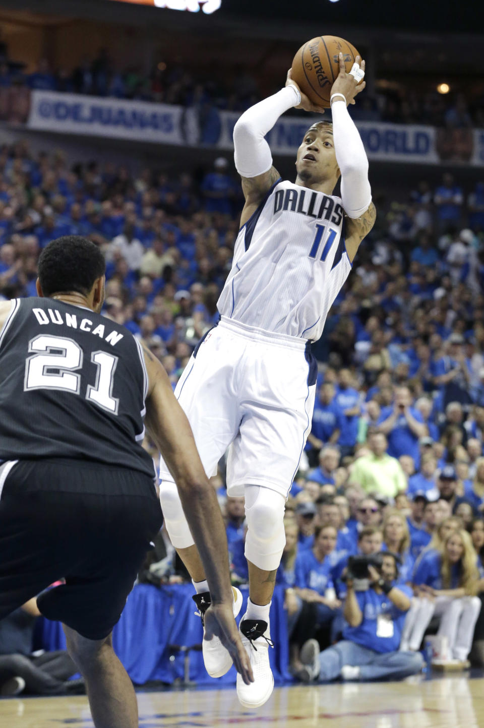 Dallas Mavericks guard Monta Ellis (11) shoots over San Antonio Spurs forward Tim Duncan (21) during the first half in Game 3 in the first round of the NBA basketball playoffs in Dallas, Saturday, April 26, 2014. (AP Photo/LM Otero)