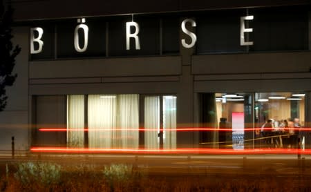 A long exposure shows traffic flowing past the illuminated word "Boerse" (exchange) at the seat of Swiss stock exchange operator SIX Group in Zurich