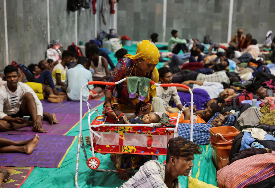 Laxmi Kumar places her son Arvind in a cradle at a temporary shelter for people evacuated from Kandla port, before the arrival of Cyclone Biparjoy, in Gandhidham, Gujarat state, India, June 13, 2023. / Credit: Reuters/Francis Mascarenhas