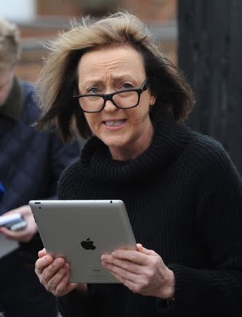 Dee Milligan-Bott, co-owner of Irish setter Jagger speaks to members of the media outside her home in Kilby, central England March 9, 2015. REUTERS/Stringer