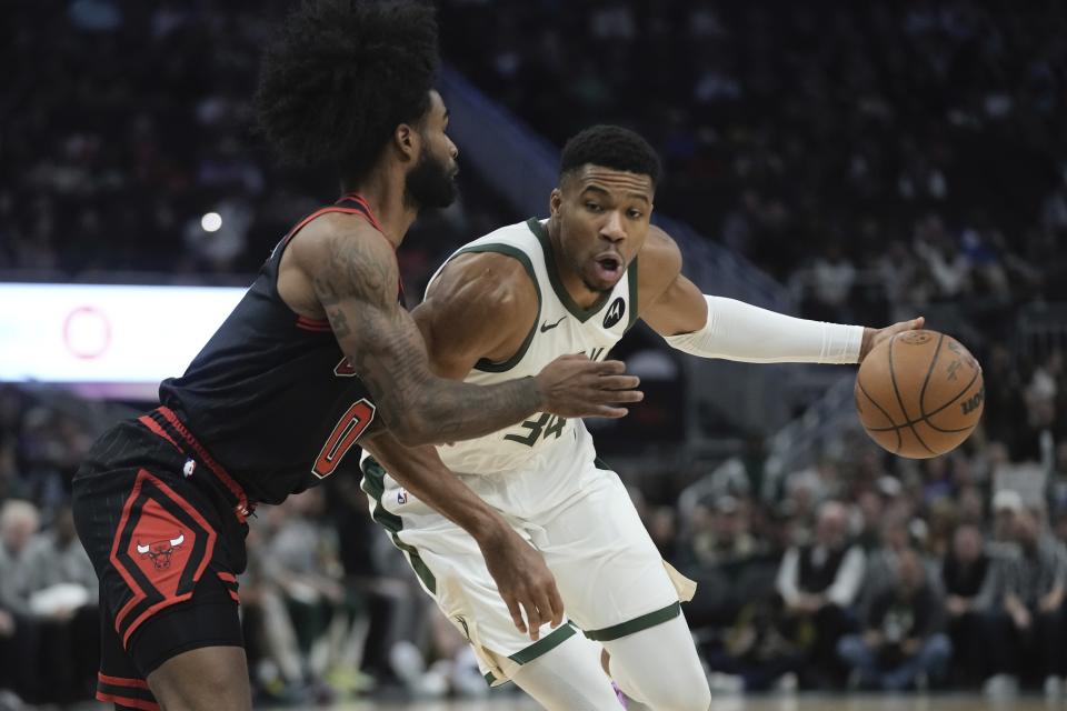 Milwaukee Bucks' Giannis Antetokounmpo tries to get past Chicago Bulls' Coby White during the first half of an NBA basketball game Monday, Nov. 13, 2023, in Milwaukee. (AP Photo/Morry Gash)