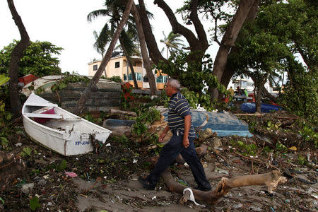 A man walks past boats lying on the seashore in the aftermath of Hurricane Irma in Puerto Plata, Dominican Republic, September 8, 2017. REUTERS/Ricardo Rojas