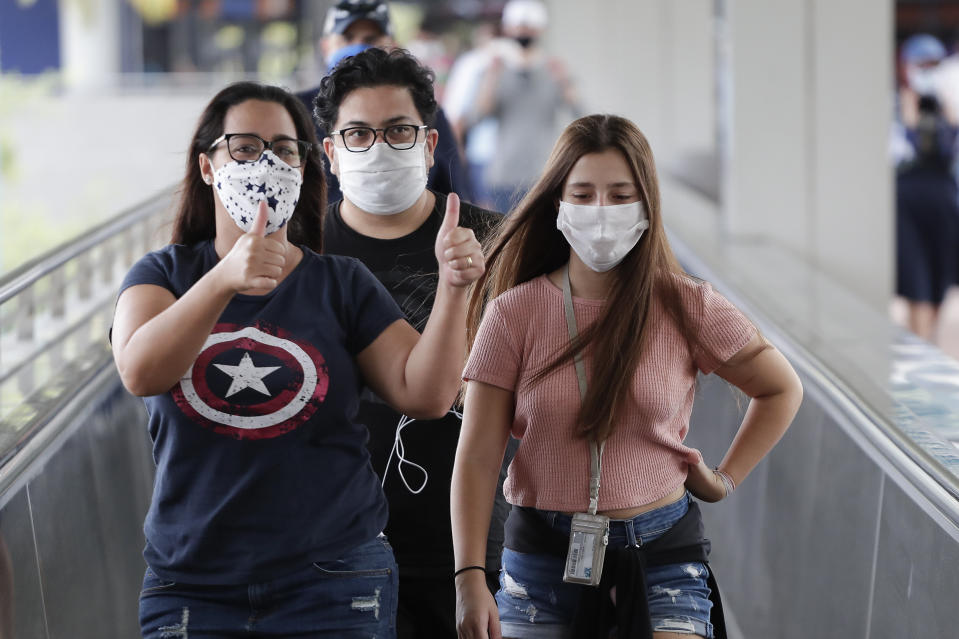 In this Wednesday, June 3, 2020 photo, guests arrive at Universal Orlando Resort Wednesday, June 3, 2020, in Orlando, Fla. The theme park has reopened for season pass holders and will open to the general public on Friday, June 5. (AP Photo/John Raoux)