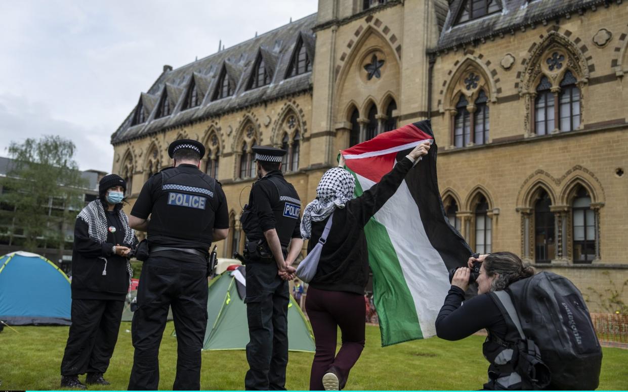 Police officers speak to Pro-Palestine student activists in their encampment in front of the Oxford University Museum of Natural History