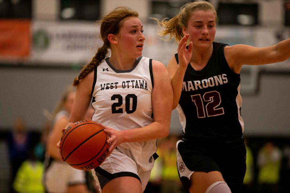 West Ottawa's Chelsea Overbeek takes the ball to the paint against Holland Christian's Tryna VanderZwaag Friday, Dec. 2, 2022, at West Ottawa High School. 