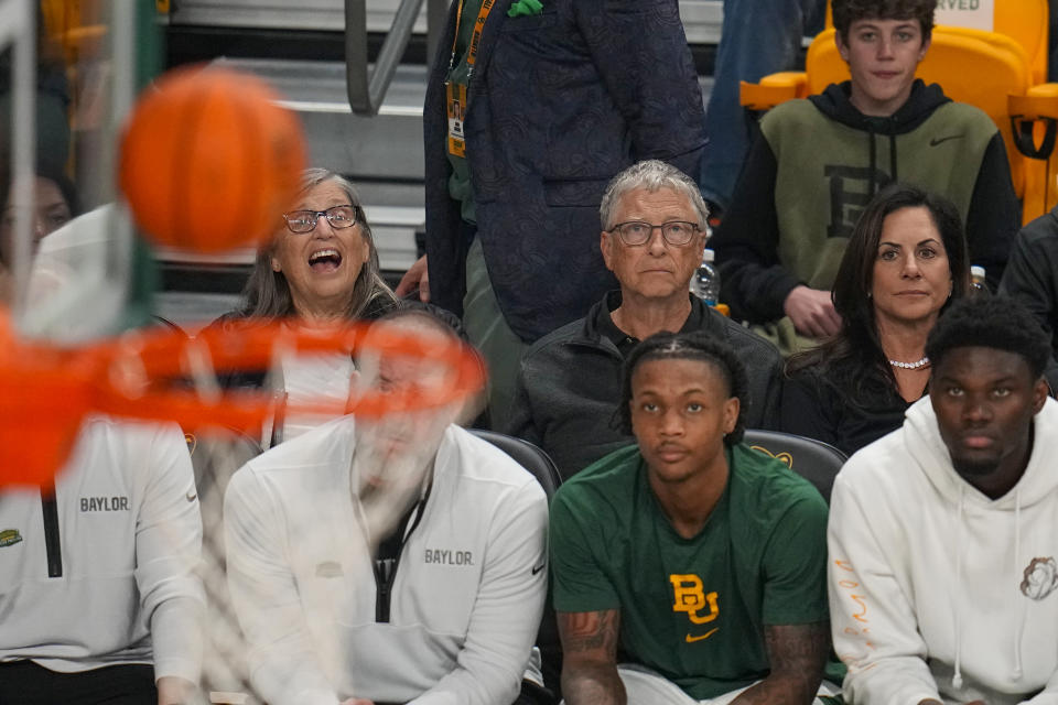 Bill Gates, second from top right, sits with his girlfriend, Paula Hurd, behind the Baylor bench during the first half of an NCAA college basketball game between Baylor and Cornell, Tuesday, Jan. 2, 2024, in Waco, Texas. (AP Photo/Julio Cortez)