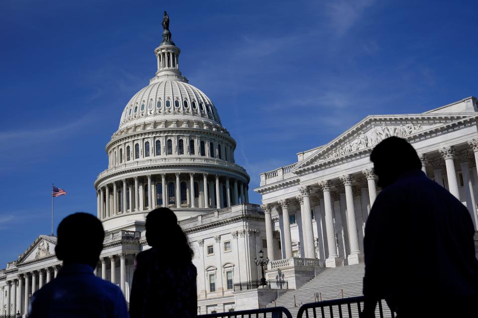 FILE - People walk outside the U.S Capitol building in Washington, June 9, 2022. The biggest investment ever in the U.S. to fight climate change. A hard-fought cap on out-of-pocket prescription drug costs for seniors in the Medicare program. A new corporate minimum tax to ensure big businesses pay their share. And billions leftover to pay down federal deficits. (AP Photo/Patrick Semansky, File) ORG XMIT: WX204