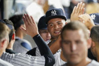 New York Yankees pitcher Luis Gil is congratulated by teammates as he comes into the dugout after pitching during the sixth inning of the team's baseball game against the Baltimore Orioles, Tuesday, Aug. 3, 2021, in New York. Gil gave up four hits and no runs in his six innings. (AP Photo/Mary Altaffer)