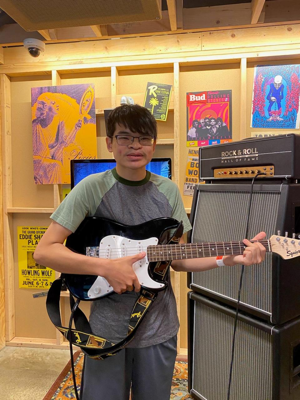 Alex Nowicki poses with a guitar during a visit to the Rock & Roll Hall of Fame in Cleveland, Ohio.