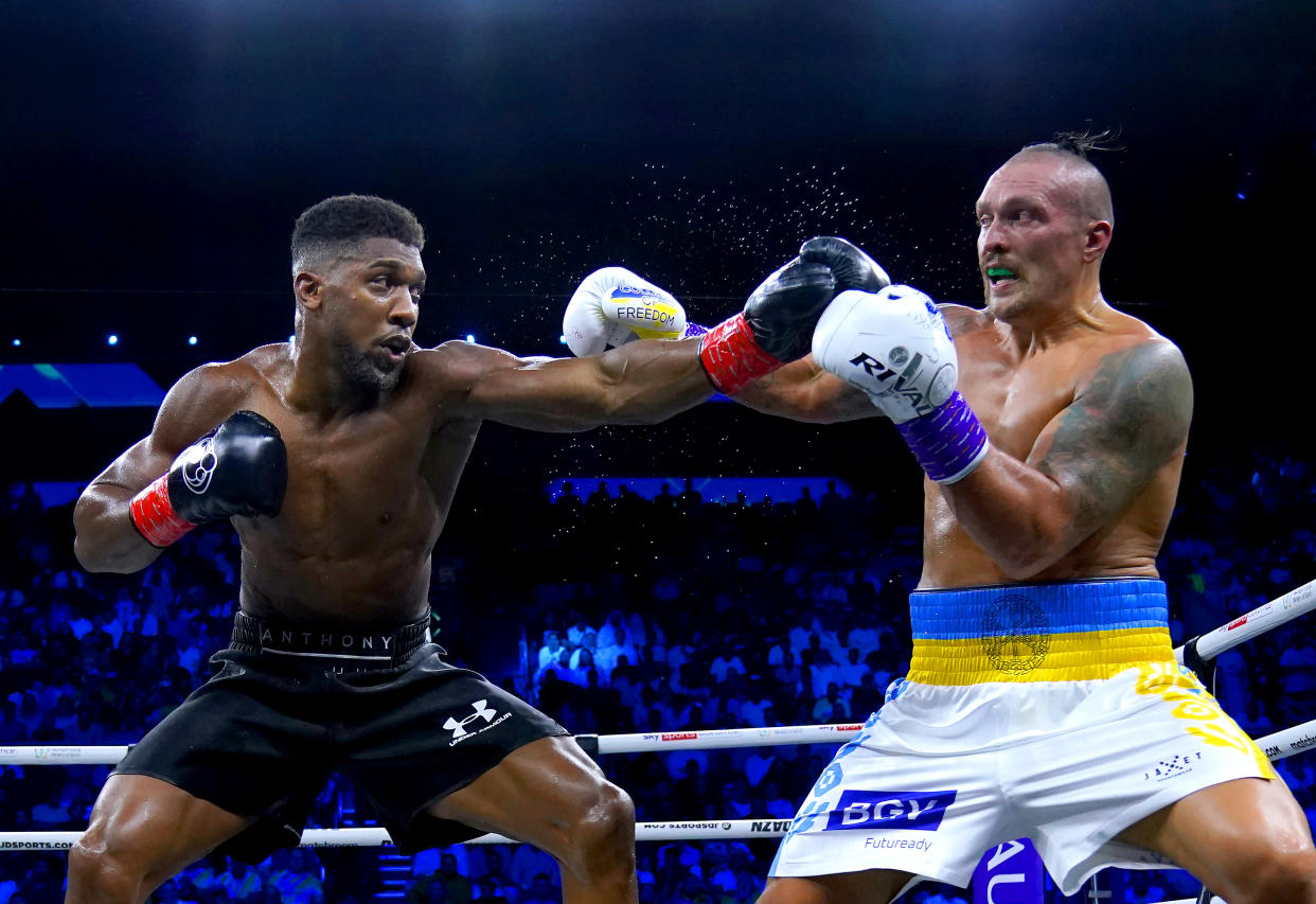 Anthony Joshua (left) and Oleksandr Usyk in action during their World Heavyweight Championship WBA Super IBF, IBO and WBO fight at the King Abdullah Sport City Stadium in Jeddah, Saudi Arabia. Picture date: Saturday August 20, 2022. (Photo by Nick Potts/PA Images via Getty Images)