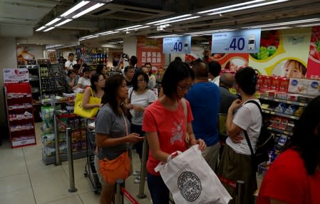 People queue in a supermarket in Admiralty district, in Hong Kong