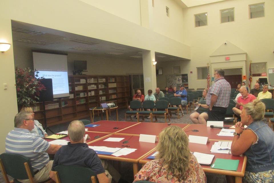 West Holmes Superintendent Eric Jurkovic delivers a power point presentation to the board of education and visitors to Monday's school board meeting about plans for a new elementary school building in the district.