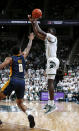 Michigan State's Gabe Brown, right, shoots over Toledo's Ra'Heim Moss (0) during the first half of an NCAA college basketball game, Saturday, Dec. 4, 2021, in East Lansing, Mich. (AP Photo/Al Goldis)