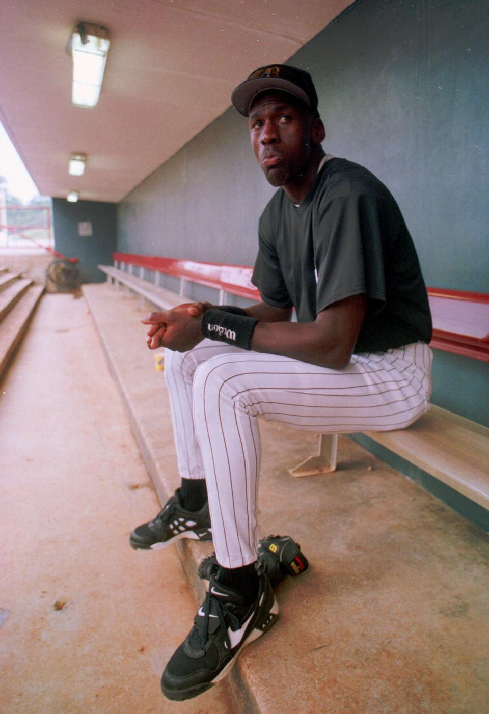 Michael Jordan sits in the dugout of the Hoover Metropolitan Stadium on the first day of practice as a minor league ball player on April 6, 1994. (AP Photo/Dave Martin)