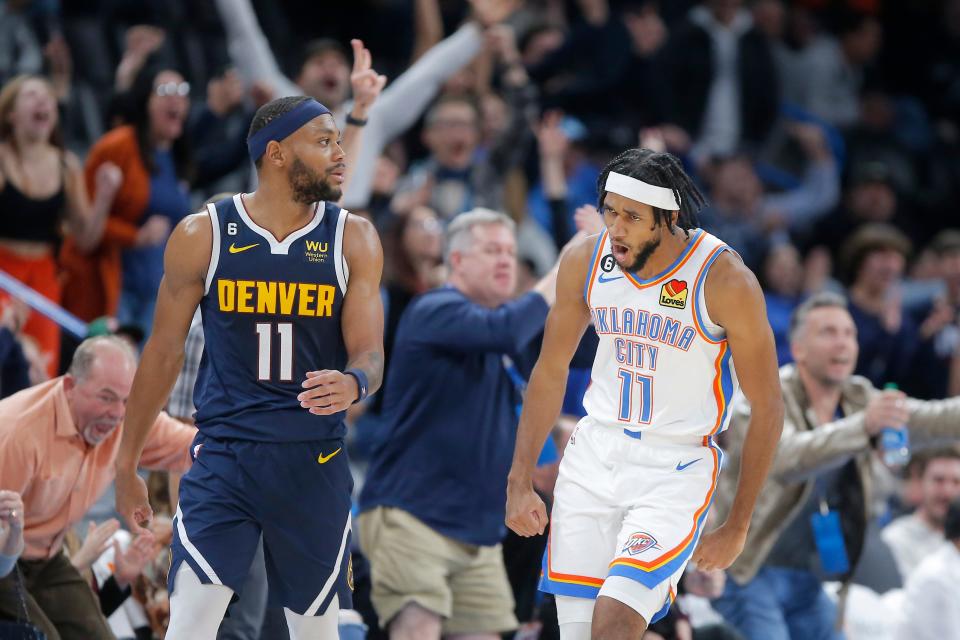 Oklahoma City guard Isaiah Joe, right, celebrates beside Denver forward Bruce Brown after making a 3-pointer during a game at Paycom Center on Nov. 23.