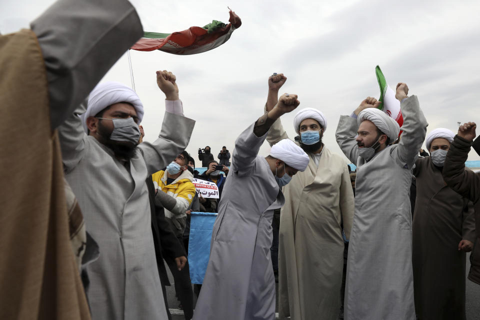 Clerics chant slogans during the annual rally commemorating the anniversary of Iran's 1979 Islamic Revolution in Azadi (freedom) Square in Tehran, Iran, Friday, Feb. 11, 2022. Thousands of cars and motorbikes paraded in the celebration, although fewer pedestrians were out for a second straight year due to concerns over the coronavirus pandemic. (AP Photo/Vahid Salemi)