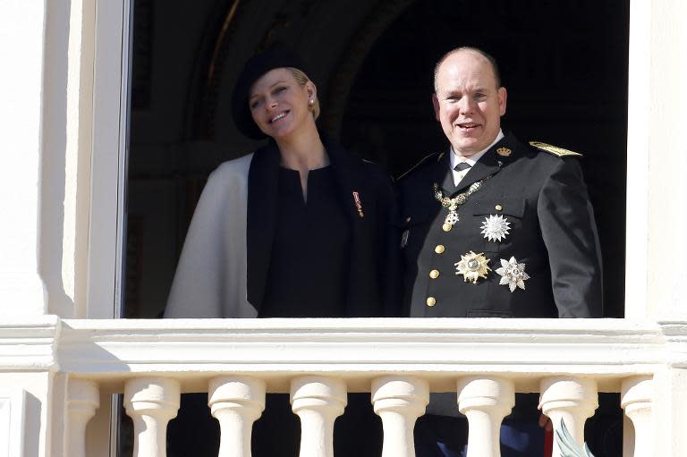 Princess Charlene of Monaco and Prince Albert II appear on the balcony of the Monaco Palace in Monaco on November 19, 2014