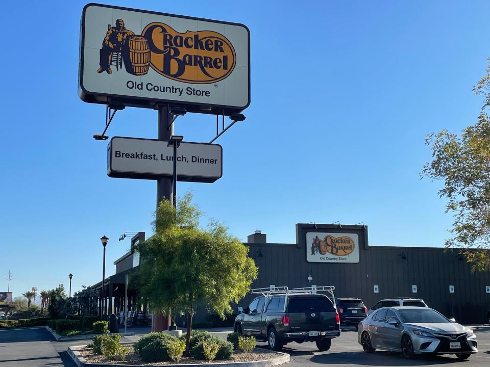 Outside of Cracker Barrel building with sign next to restaurant