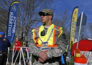 A military policeman stands near the start line of the 118th Boston Marathon Monday, April 21, 2014 in Hopkinton, Mass. (AP Photo/Michael Dwyer)