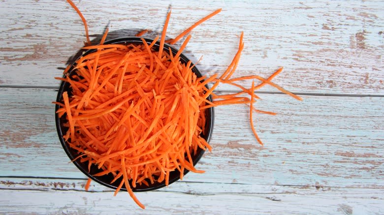 Finely shredded carrots in bowl