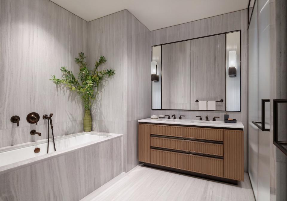 While parts of the model unit have splashes of color, the bathroom is a calming space of monotones.