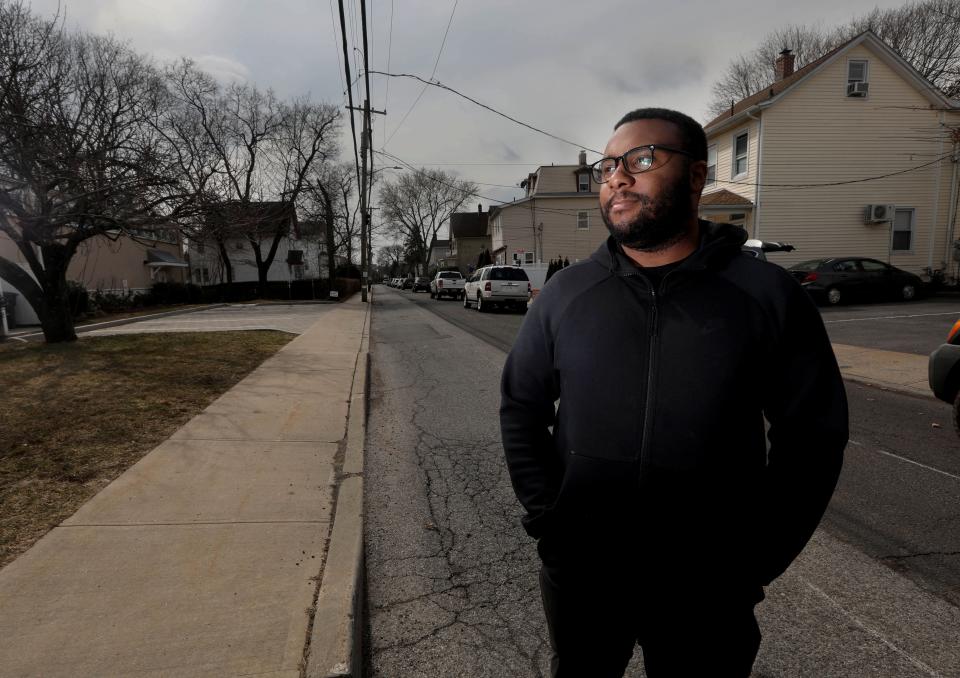 Manny Rawlings, 24, an activist and resident of the Washingtonville section of Mamaroneck, also known as The Flats, stands on Madison Street March 7, 2022. This section of Mamaroneck was devastated by Hurricane Ida in 2021, and has been impacted by flooding for decades. Rawlings is hoping that a flood mitigation project designed by the Army Corps of Engineers will bring some relief to the residents of this largely Hispanic and Black community. 