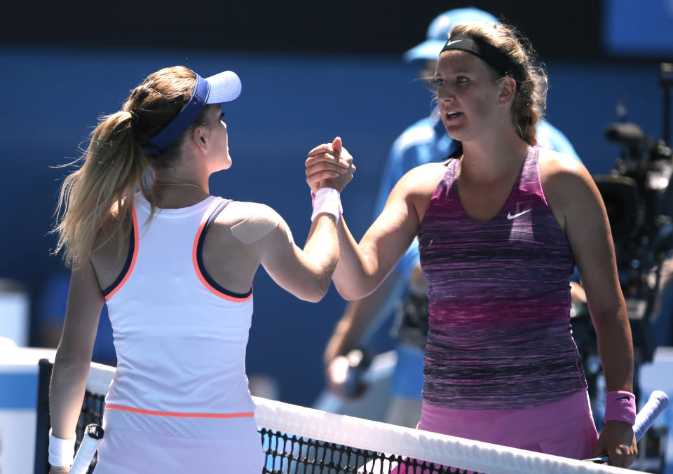 Agnieszka Radwanska of Poland, left, shakes hands with Victoria Azarenka of Belarus at the net after Radwanska won their quarterfinal at the Australian Open tennis championship in Melbourne, Australia, Wednesday, Jan. 22, 2014.(AP Photo/Rick Rycroft)