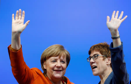 Annegret Kramp-Karrenbauer (R), State Minister-President and top candidate of the Christian Democratic Union Party (CDU) and German Chancellor Angela Merkel attend an election rally for the upcoming state elections in the Saarland in St. Wendel near Saarbruecken, Germany March 23, 2017. REUTERS/Ralph Orlowski