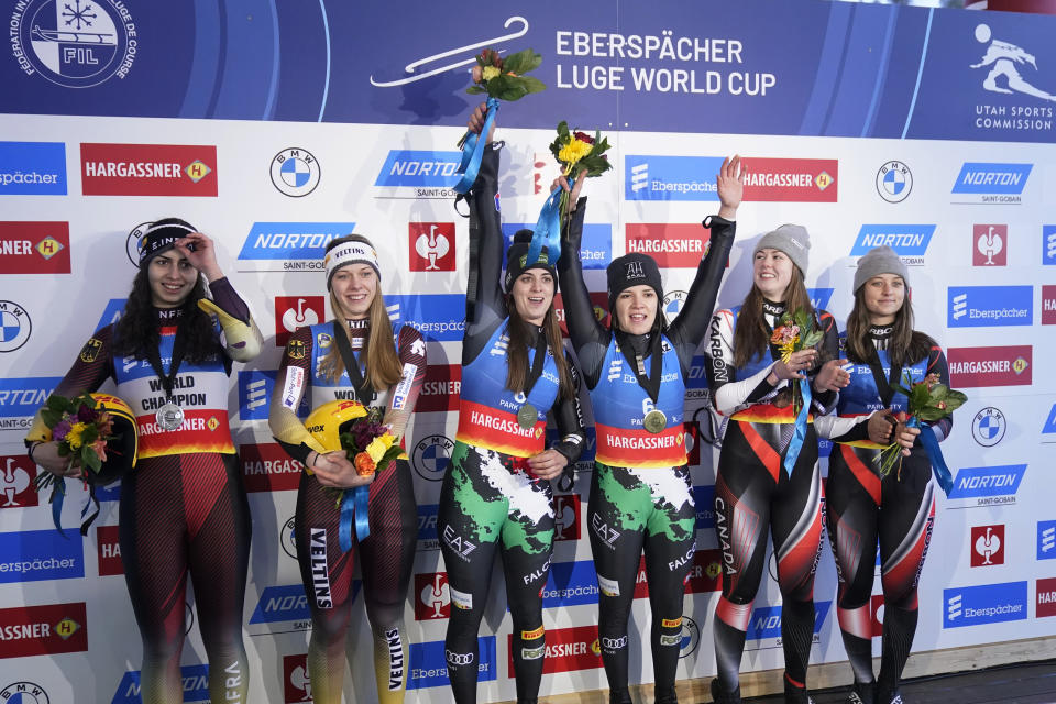 First-place finishers Italy's Andrea Votter, and Marion Oberhofer, center, share the podium with second-place finishers Germany's Jessica Degenhardt and Cheyenne Rosenthal, left, and third-place finishers Canada's Caitlin Nash and Natalie Corless, right, following the women's doubles at a World Cup luge event Friday, Dec. 16, 2022, in Park City, Utah. (AP Photo/Rick Bowmer)