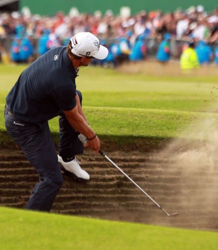 Adam Scott of Australia plays out of a bunker on the 18th fairway during his final round on day four of the 2012 British Open Golf Championship at Royal Lytham and St Annes in Lytham. Ernie Els won the championship with a score of 273, one shot clear of Adam Scott of Australia