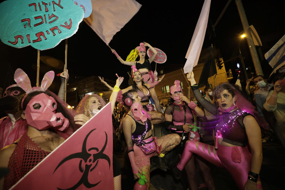 Israeli protesters chant slogans during a demonstration against Israeli Prime Minister Benjamin Netanyahu outside the Prime Minister's residence in Jerusalem, Saturday, Sept. 12, 2020. (AP Photo/Sebastian Scheiner)