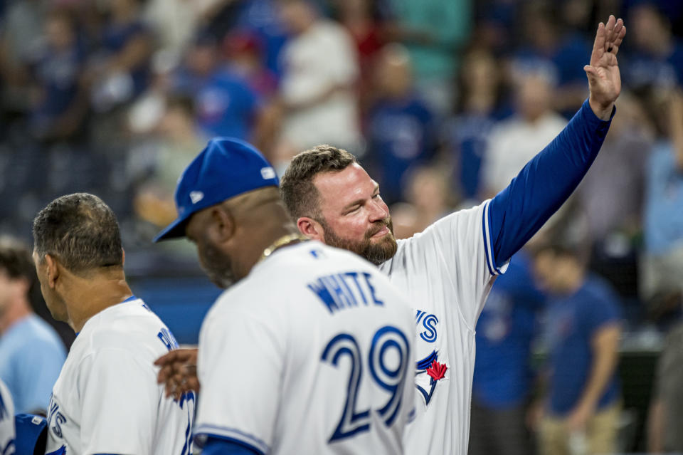 Interim manager John Schneider, right, waves to the crowd before a baseball game against the Philadelphia Phillies, Wednesday, July 13, 2022 in Toronto. (Christopher Katsarov/The Canadian Press via AP)