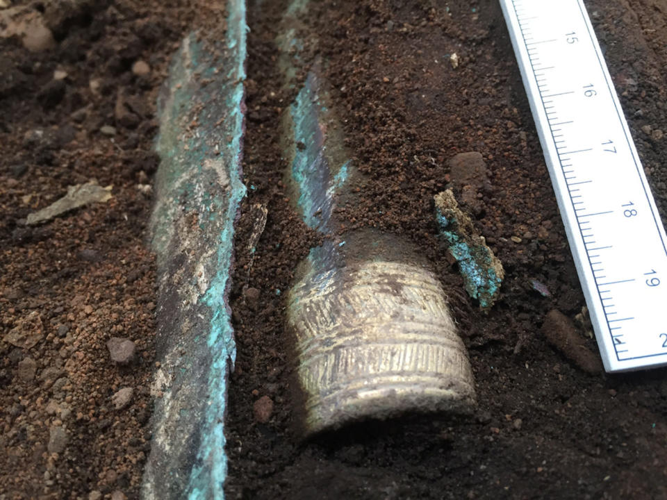 The gold-decorated socket of a Bronze Age spearhead emerges from the soil in Scotland. <cite>Guard Archaeology Ltd.</cite>