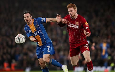 Shaun Whalley of Shrewsbury Town and Sepp Van Den Berg of Liverpool during the FA Cup Fourth Round Replay match between Liverpool and Shrewsbury - Credit: GETTY IMAGES