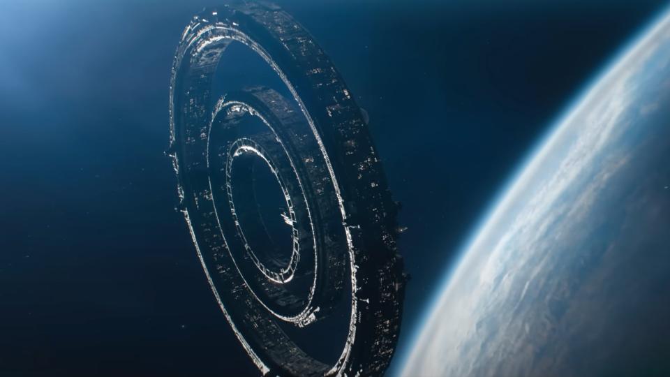 a ringed space station in orbit above a blue planet