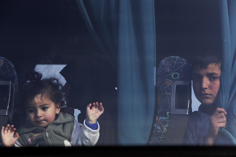 FILE - Young migrants from Syria sit in a bus as they arrive at a refugees camp at Kokkinotrimithia outside of the capital Nicosia, in the eastern Mediterranean island of Cyprus, on Saturday, Feb. 4, 2017. The president of Cyprus Nikos Christodoulides says on Tuesday, April 2, 2024, he has personally asked the head of the European Union's executive arm to intercede with Lebanese authorities so that they could put a stop to boat loads of Syrian refugees from heading to the east Mediterranean island nation. (AP Photo/Petros Karadjias, File)