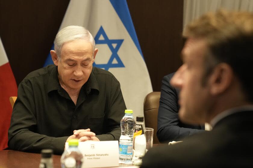 Israeli Prime Minister Benjamin Netanyahu and French President Emmanuel Macron hold talks in Jerusalem, Tuesday, Oct. 24, 2023. Emmanuel Macron is traveling to Israel to show France's solidarity with the country and further work on the release of hostages who are being held in Gaza. (AP Photo/Christophe Ena, Pool)